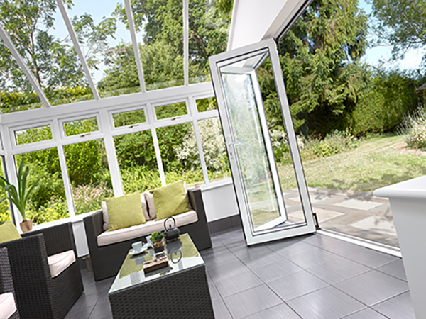 The inside of an extension with white bi-folding doors