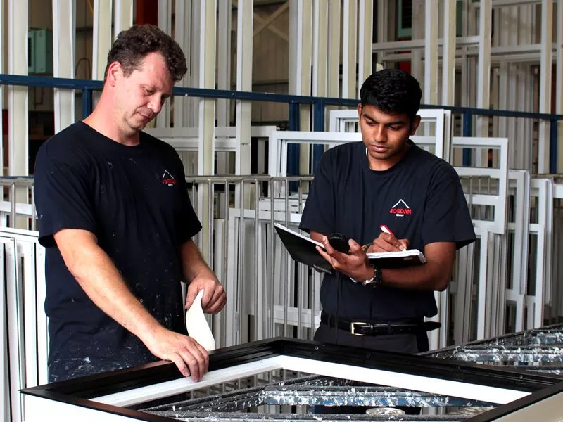 Two men quality checking windows